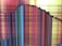 A screen display with multi-colored vertical and horizontal lines forming a pattern. The colors include reds, yellows, blues, and blacks. There are visible cracks along the surface, indicating a damaged or broken screen.