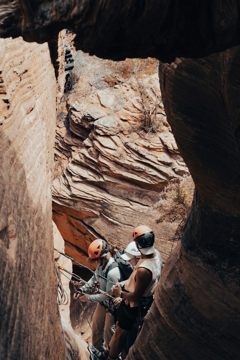 a man climbing up a steep cliff in the desert