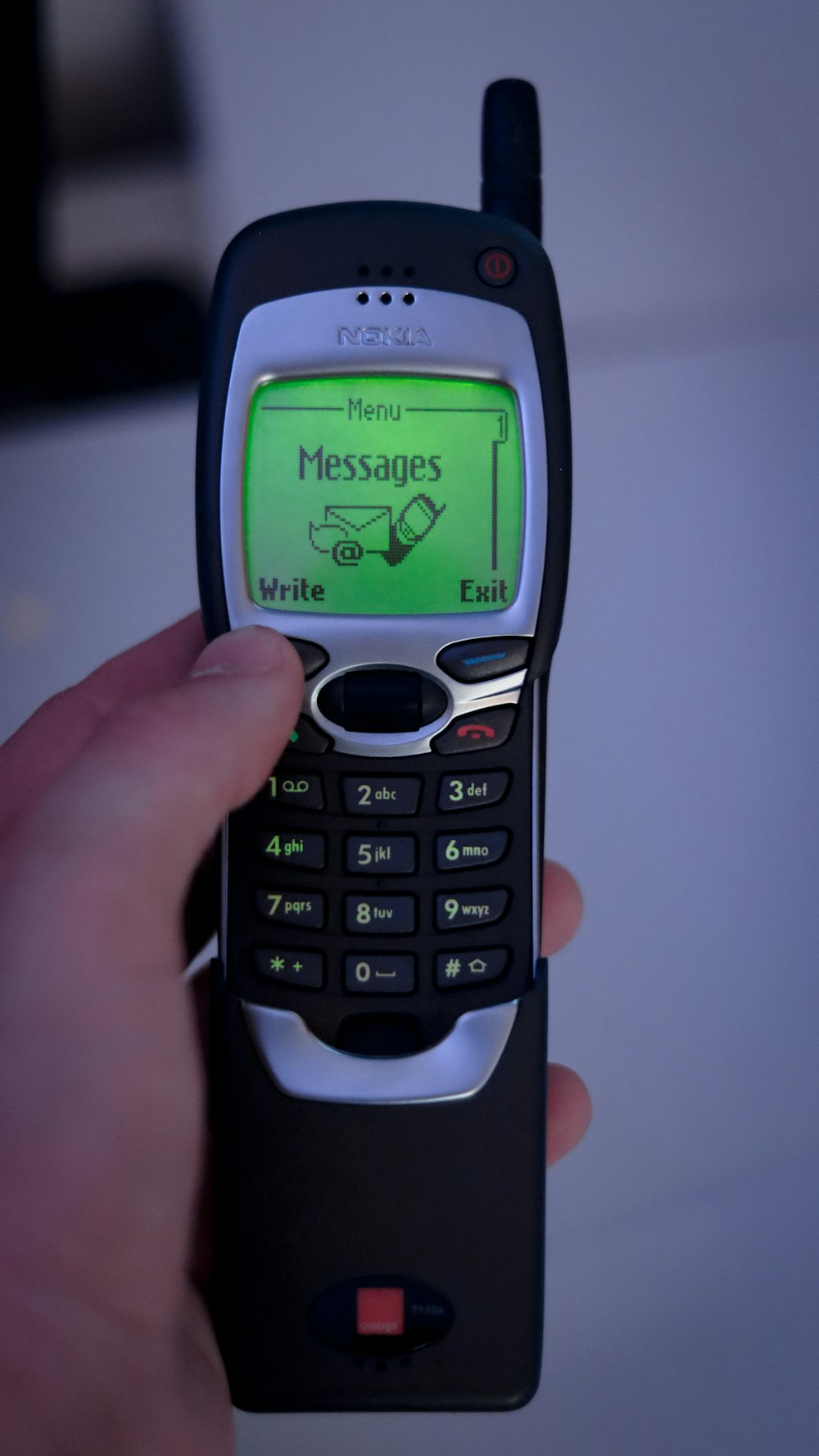 a person holding a cell phone with a message on it