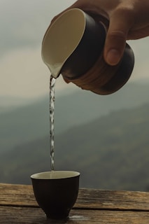 A tranquil scene of sake being poured into a cup.