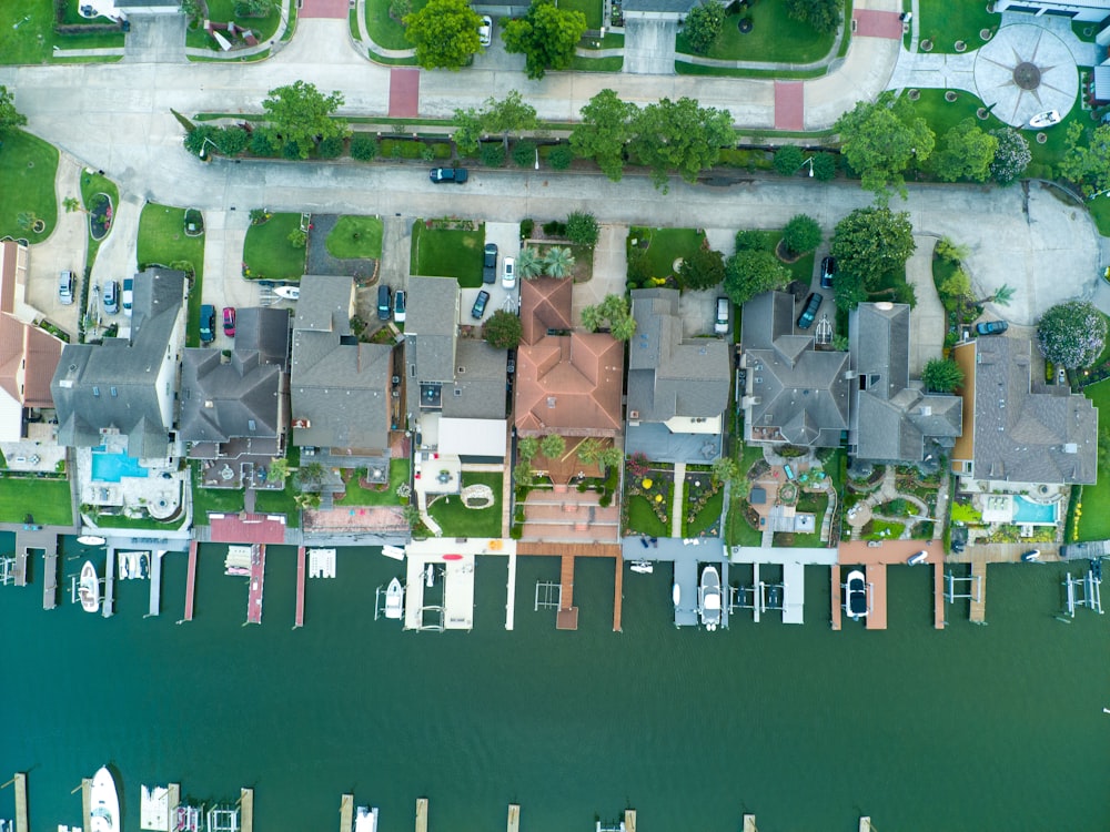 an aerial view of a neighborhood next to a body of water