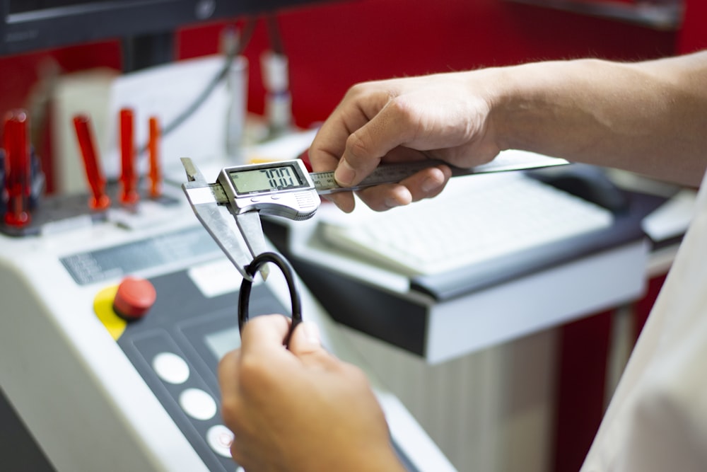 a person using a calculator on a machine