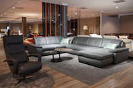 a living room filled with furniture and a wooden floor