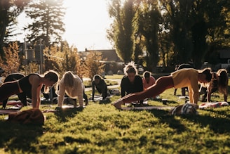 a group of people doing yoga in a park