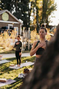 a group of people doing yoga in a park