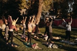 a group of people doing yoga in a park