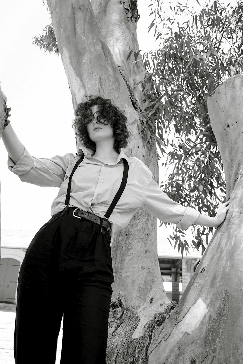 a woman standing in front of a tree