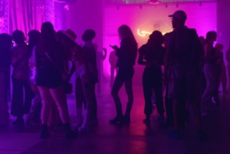 a group of people standing around in a room for party