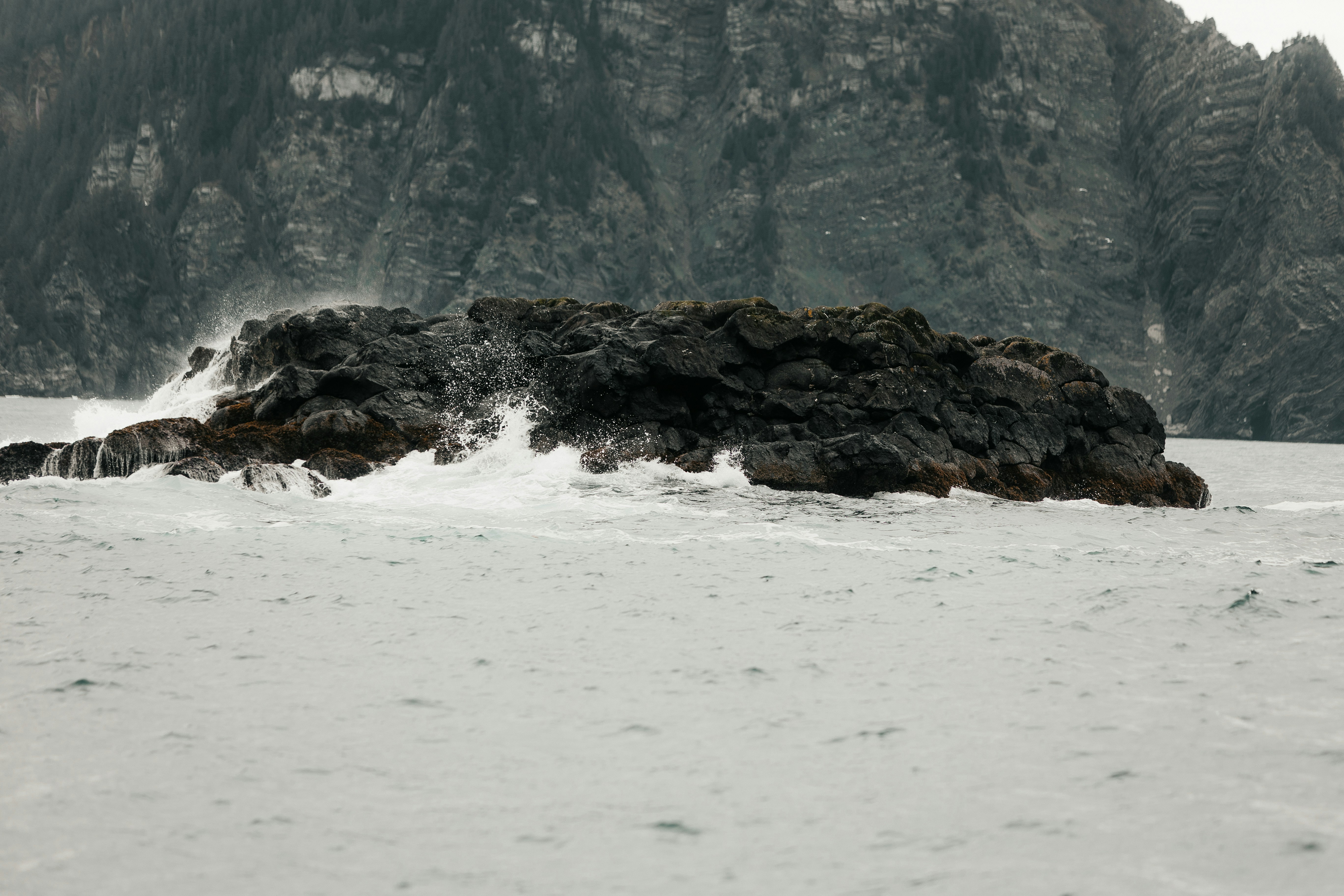 a rock outcropping in the middle of a body of water
