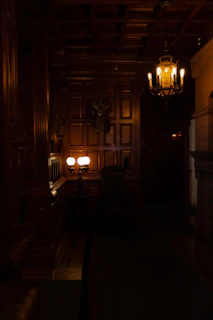 a dimly lit room with a chandelier hanging from the ceiling