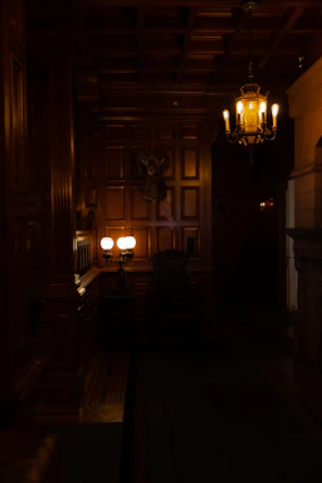 a dimly lit room with a chandelier hanging from the ceiling
