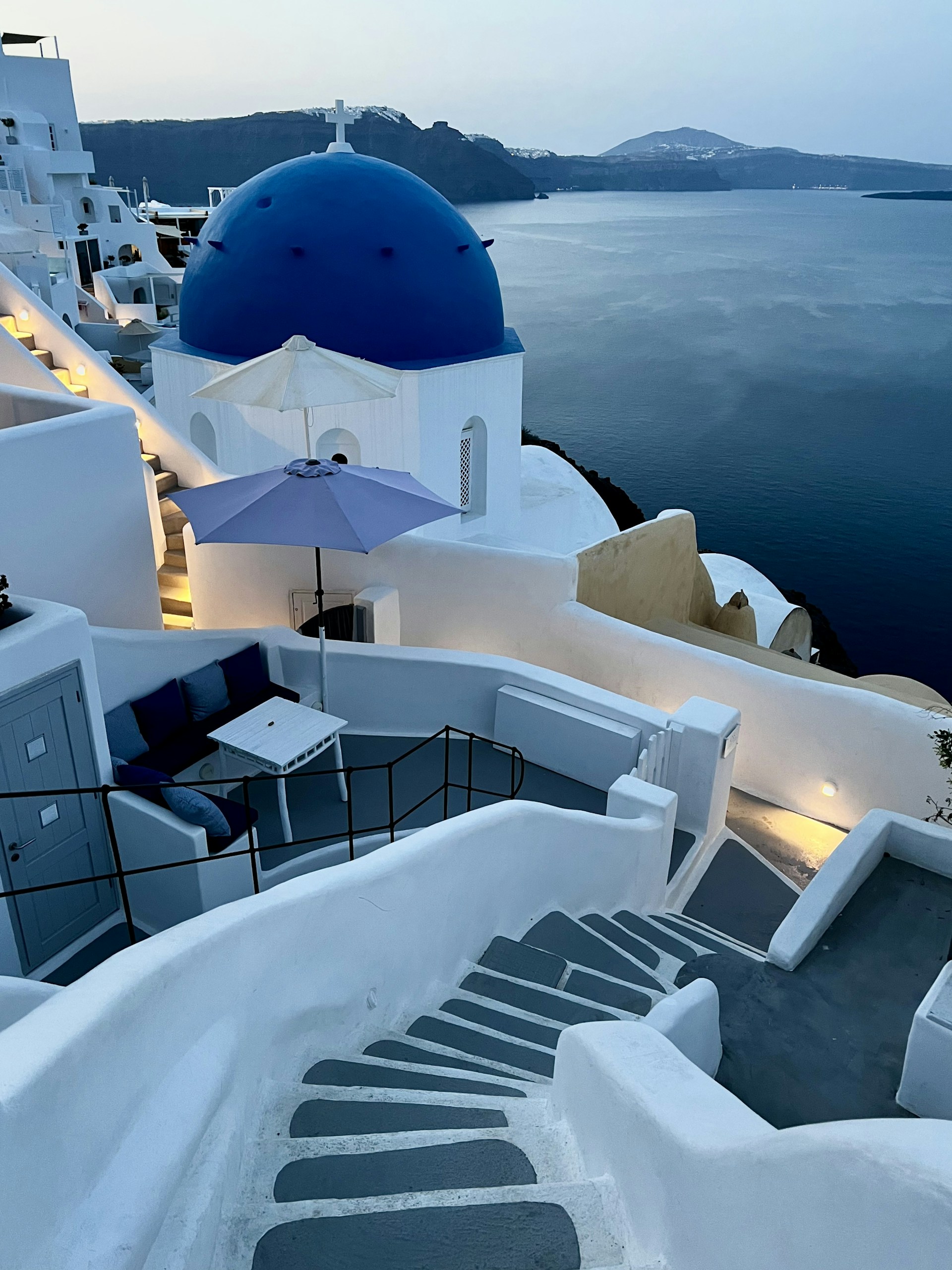 Sunlit terrace of Villa Eris Antiparos overlooking the sparkling Aegean Sea with white Cycladic architecture.