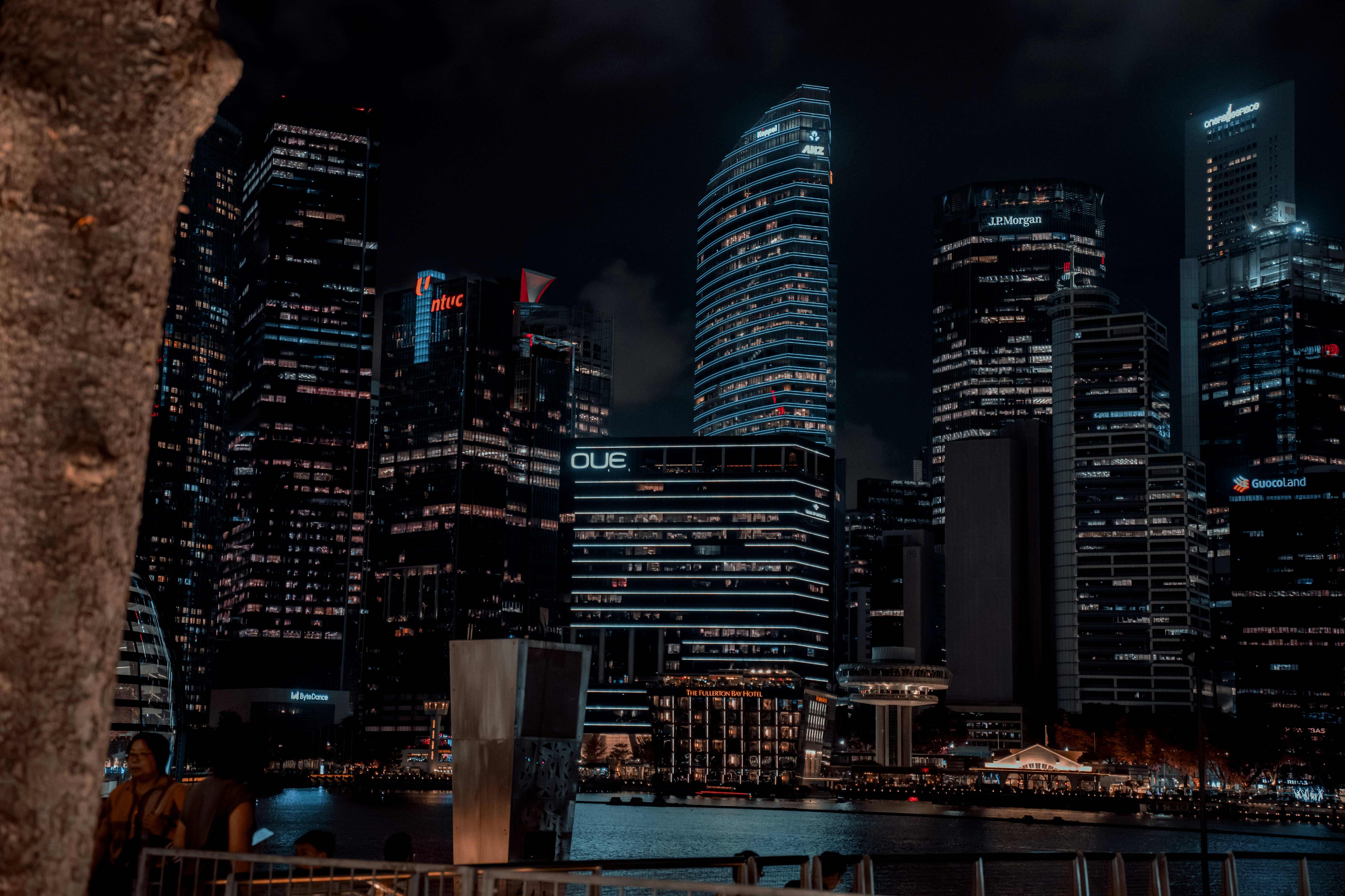 a city skyline at night with tall buildings