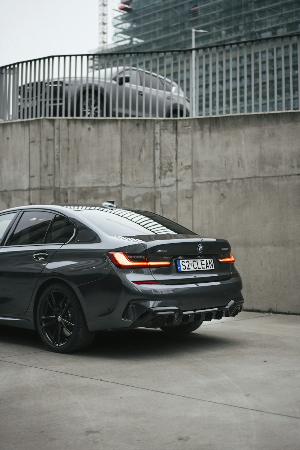 a grey car parked in front of a building