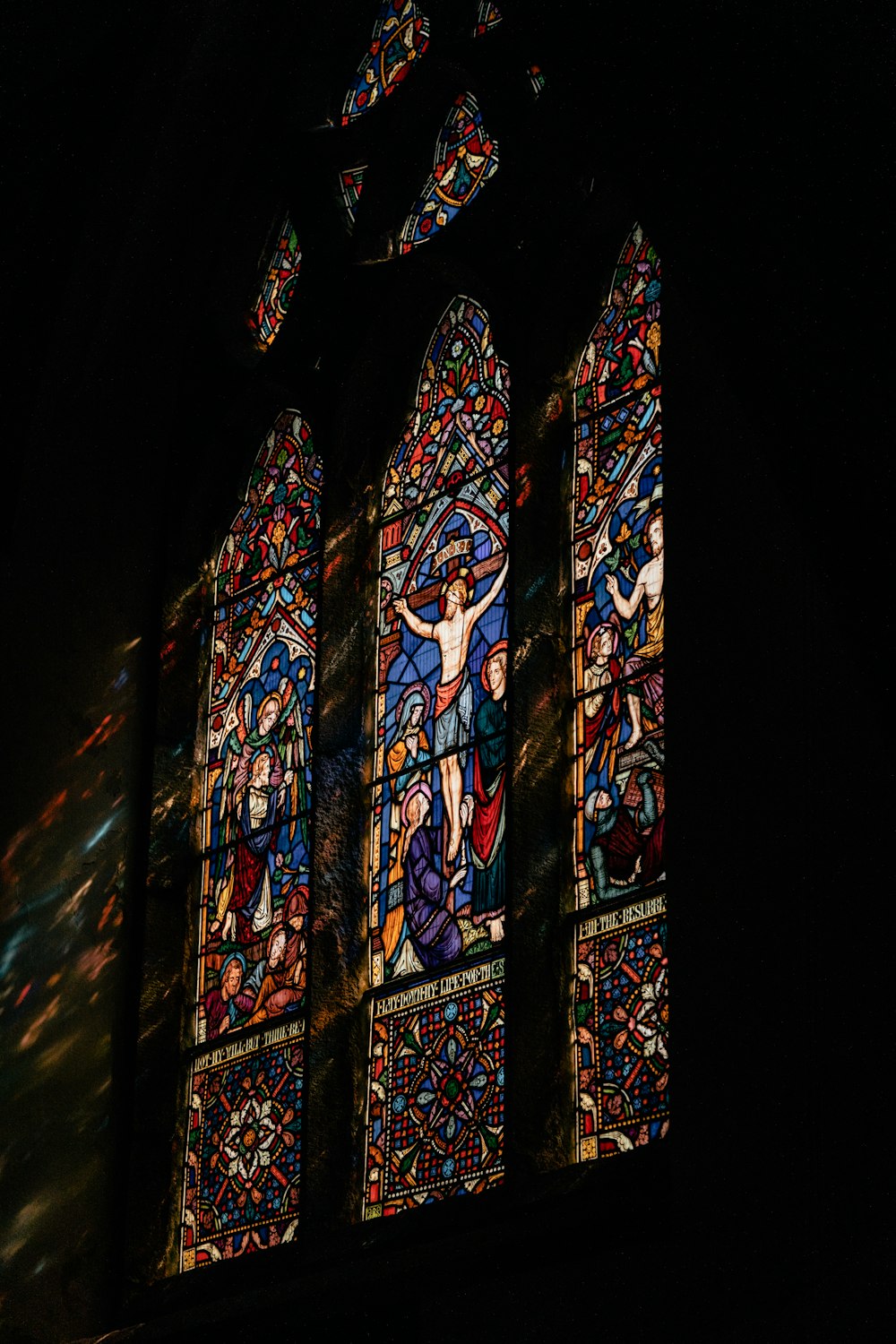 a stained glass window in a dark room