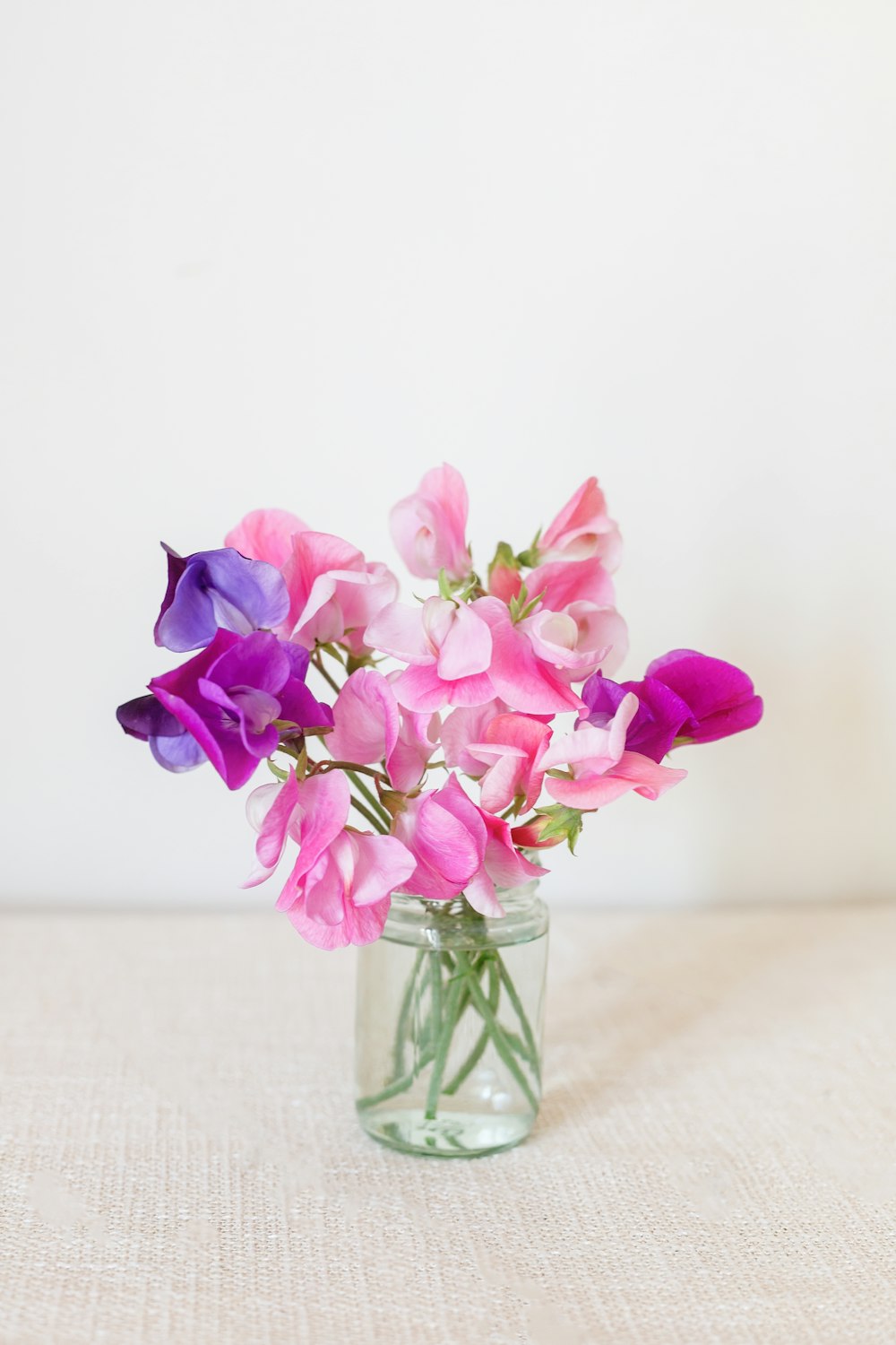 a vase filled with purple and pink flowers