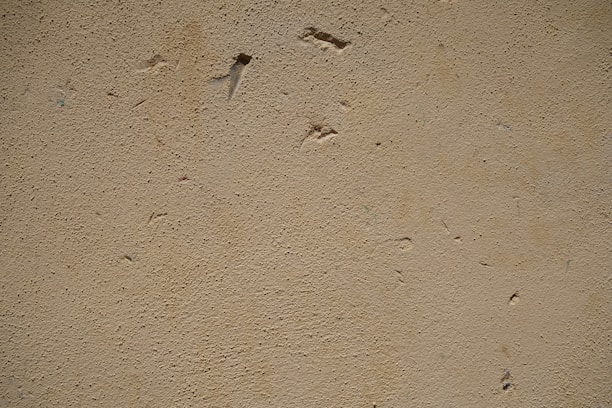 Close-up of a handyman carefully patching a wall with smooth texture matching.