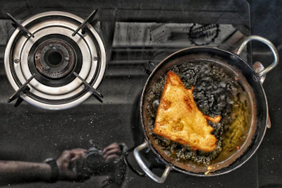 a frying pan filled with food on top of a stove