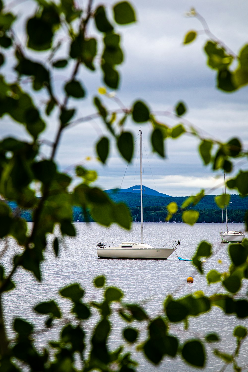 a couple of boats floating on top of a lake