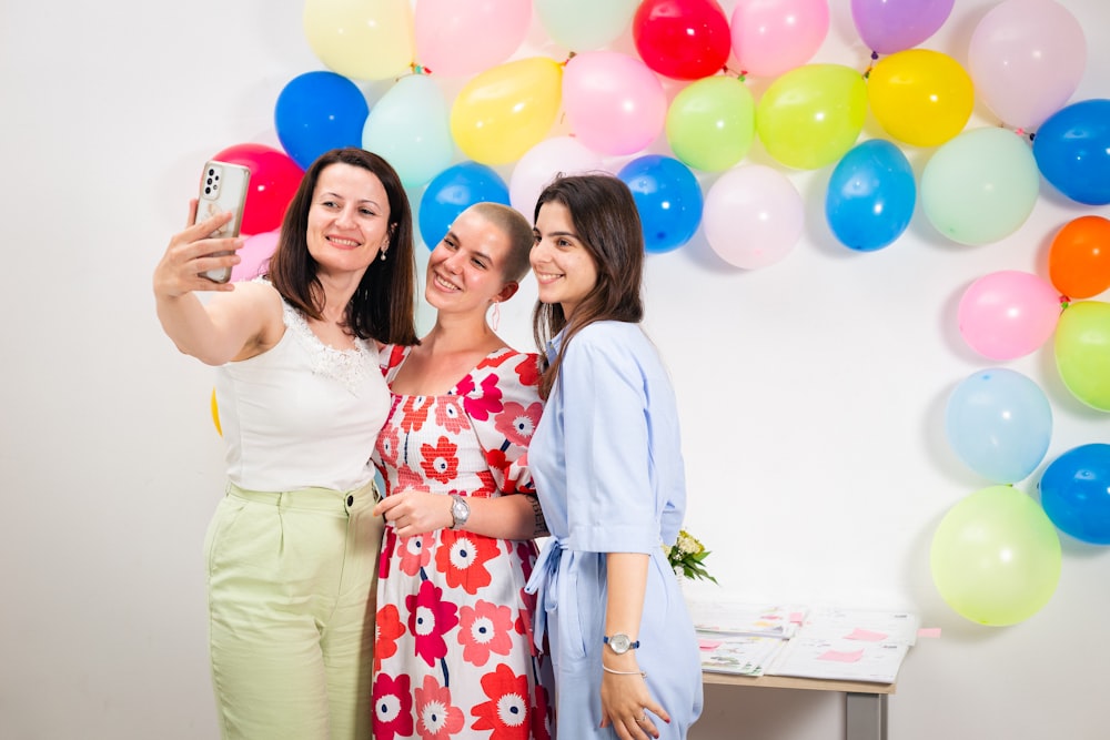 two women taking a picture with a cell phone