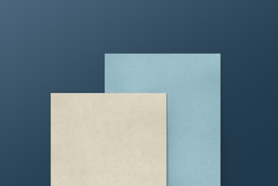 a blue and a white paper on a blue background