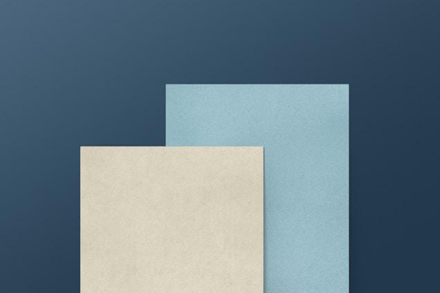 a blue and a white paper on a blue background