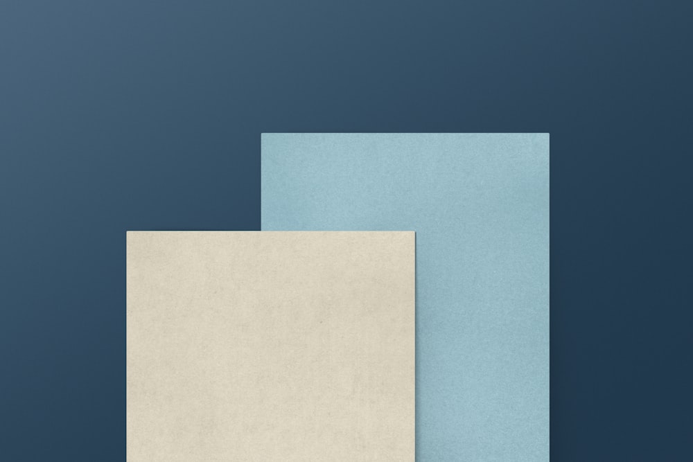 a blue and a white paper on a blue background