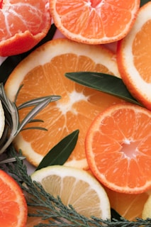 A fresh citrus arrangement with lemons, oranges, and green leaves representing fresh scents