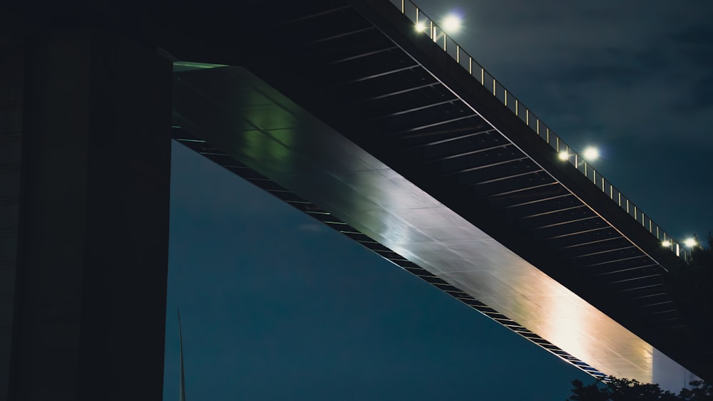 Un puente iluminado por la noche con las luces encendidas