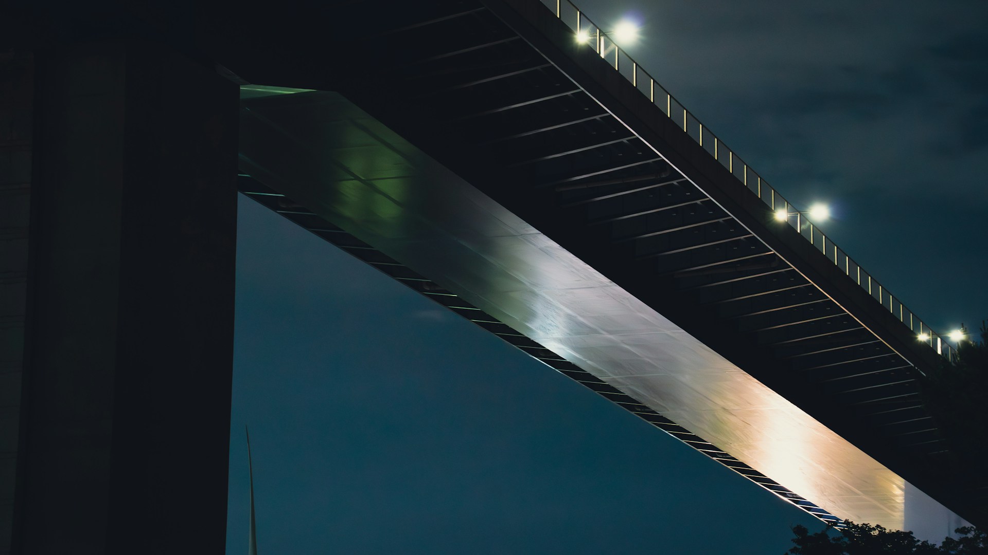 A sleek, minimalist thumbnail of a futuristic railway bridge at dusk, highlighting clean lines and subtle lighting.