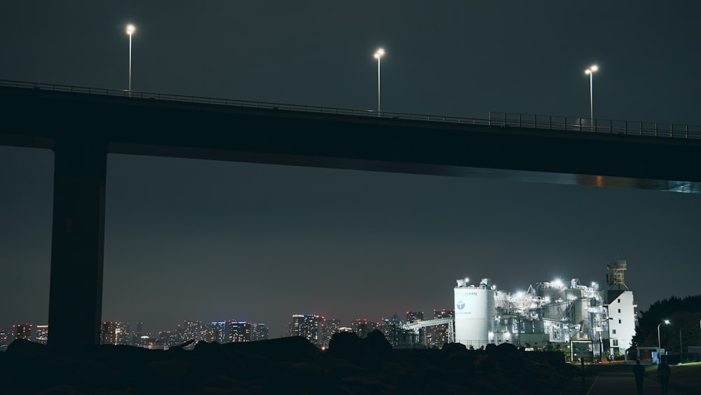 a bridge over a city at night with lights on