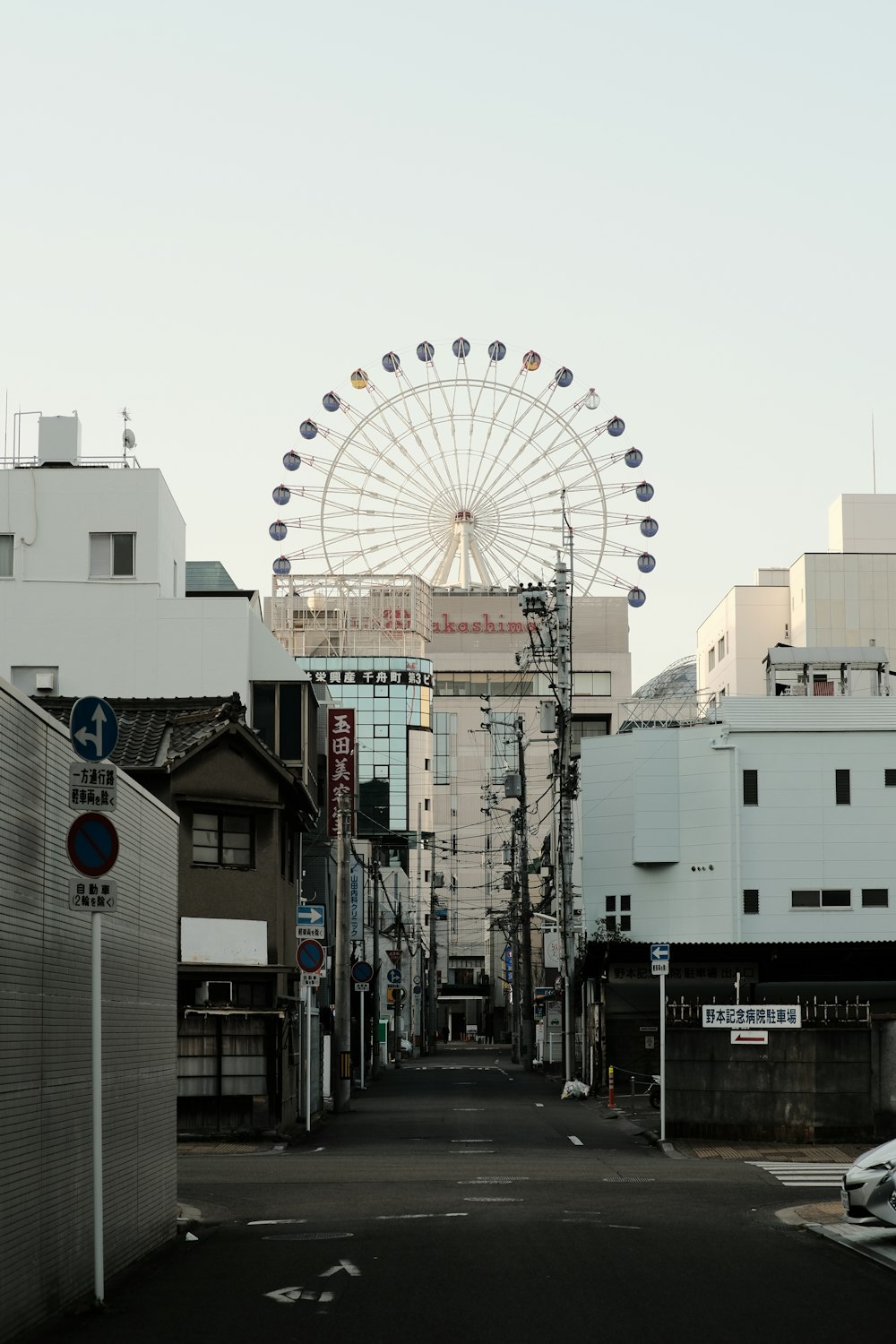 a street with a ferris wheel in the background