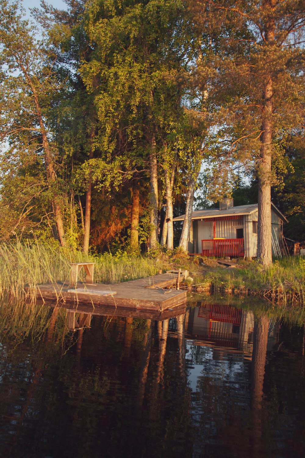 a boat dock sitting in the middle of a lake