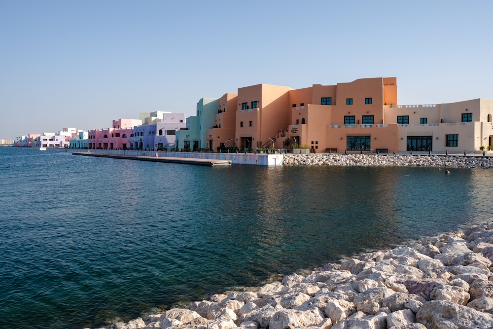 a body of water next to a row of buildings