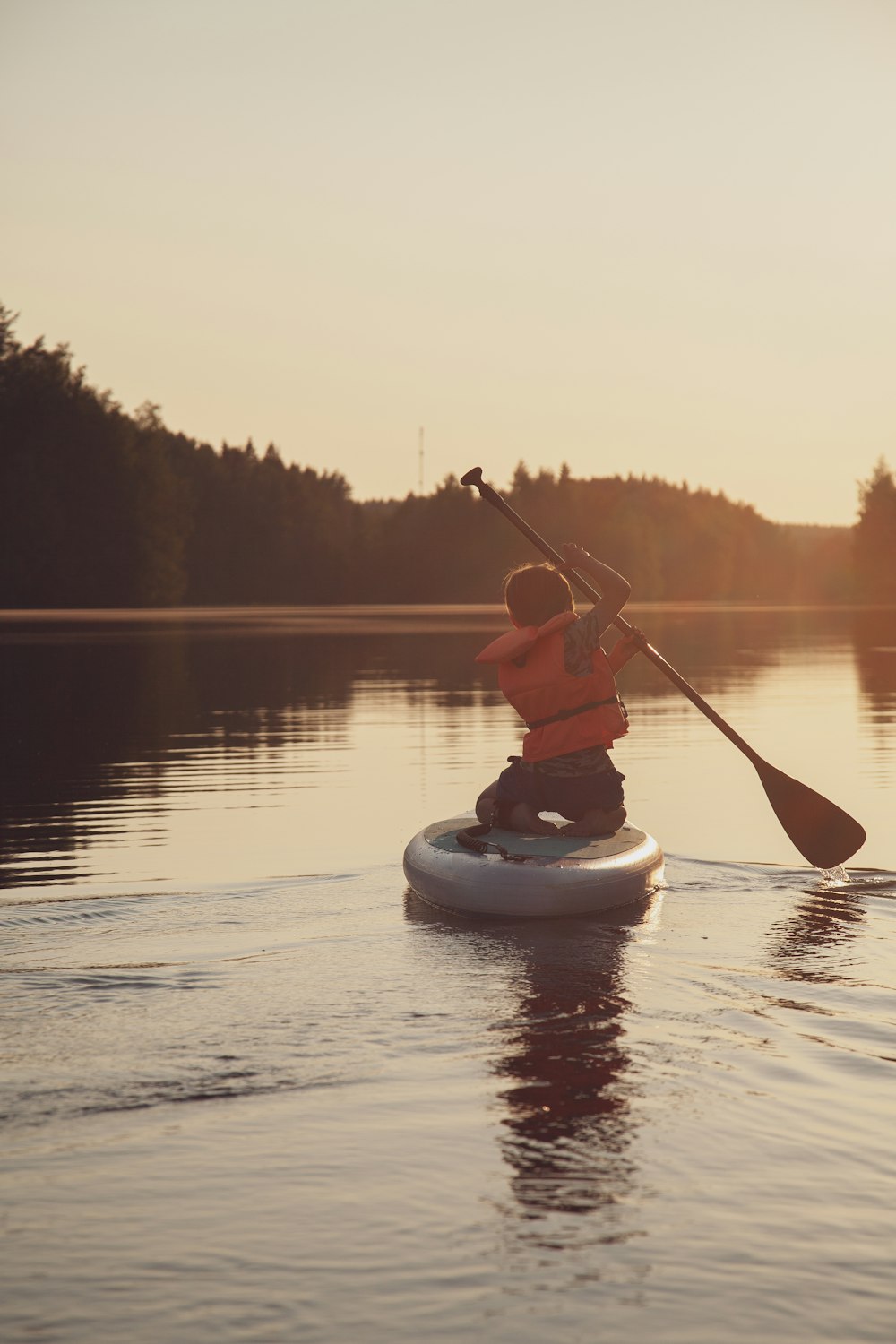 a person riding a paddle board on a body of water