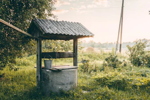 Detailed image showing the smooth finish of a newly constructed water well surrounded by natural greenery