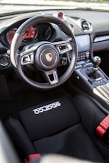the interior of a car with a steering wheel and dashboard