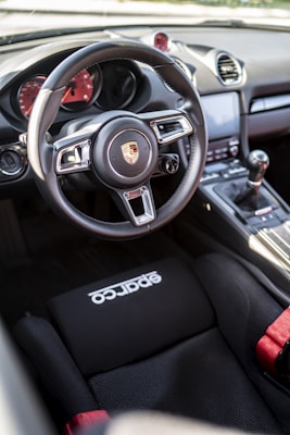 the interior of a car with a steering wheel and dashboard
