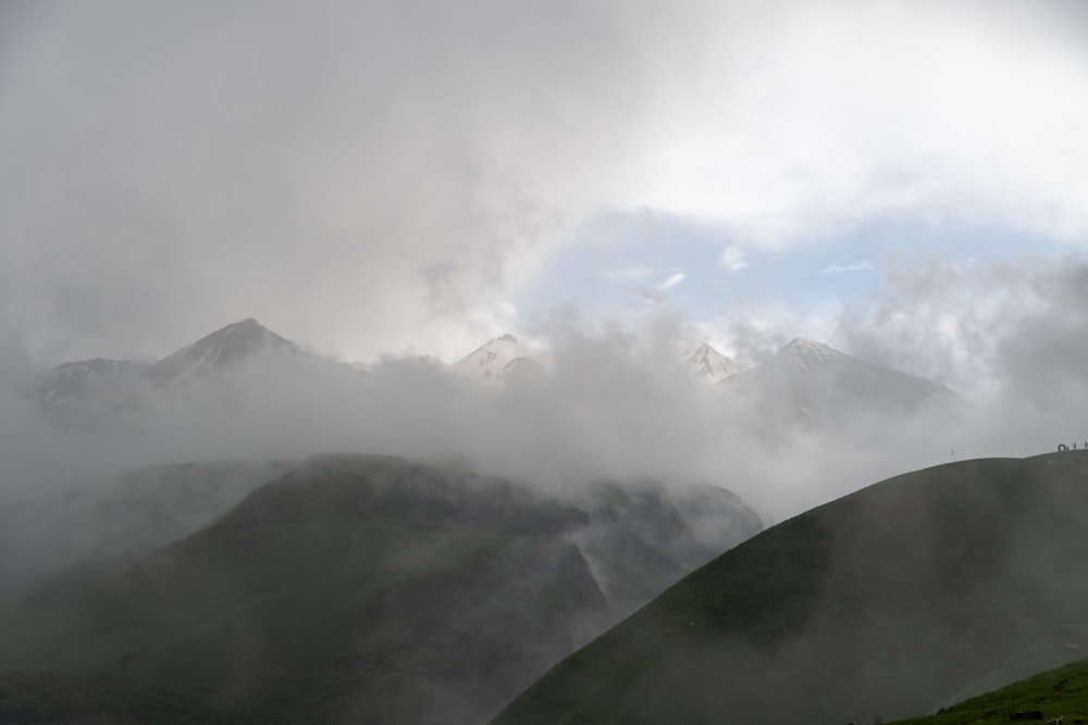 a view of a mountain range covered in clouds