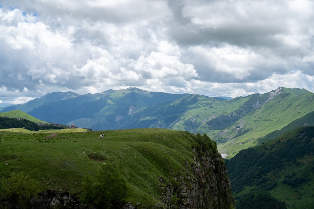 a view of a valley with mountains in the background