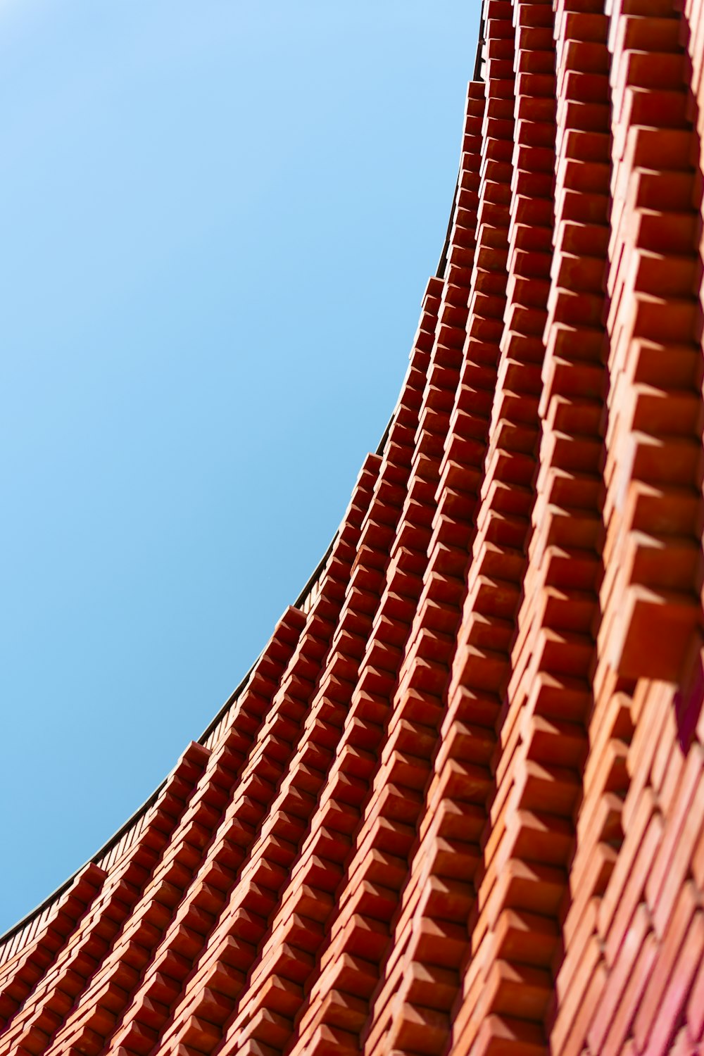 a tall red building with a clock on it's side