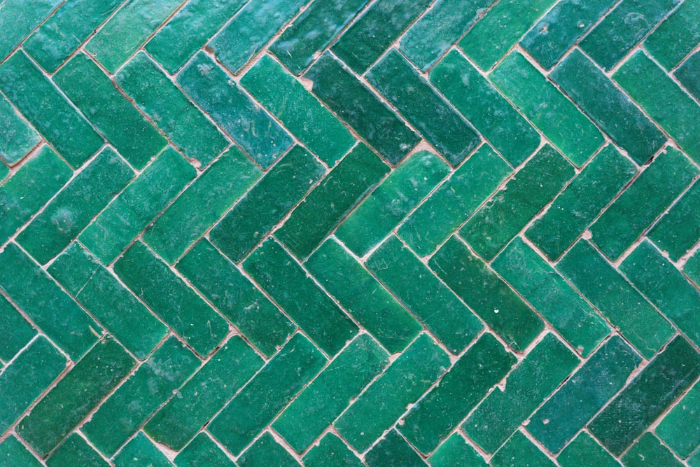 a close up of a green brick wall