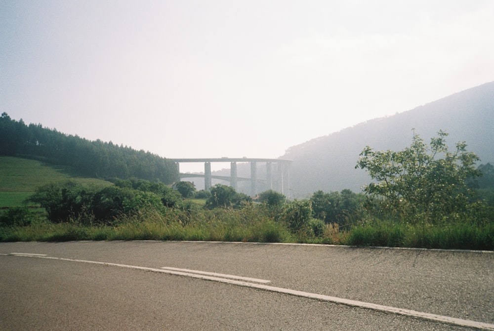 a road with a bridge in the distance