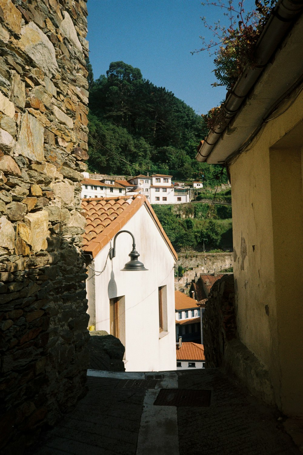 a white building with a bell on the side of it