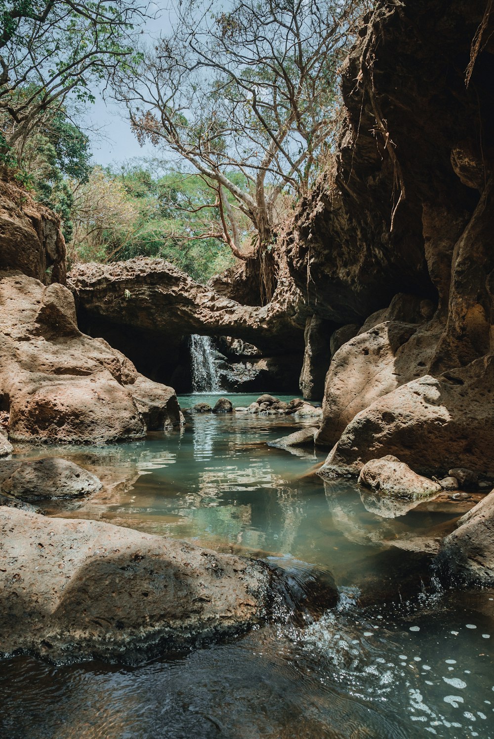 a small waterfall in the middle of some rocks