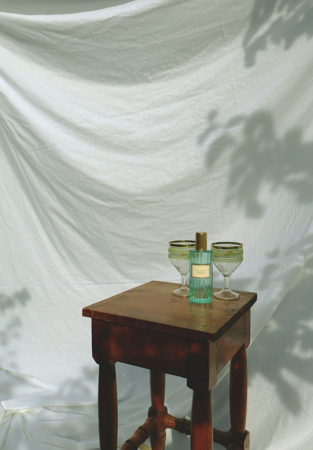 a wooden table with two wine glasses on top of it