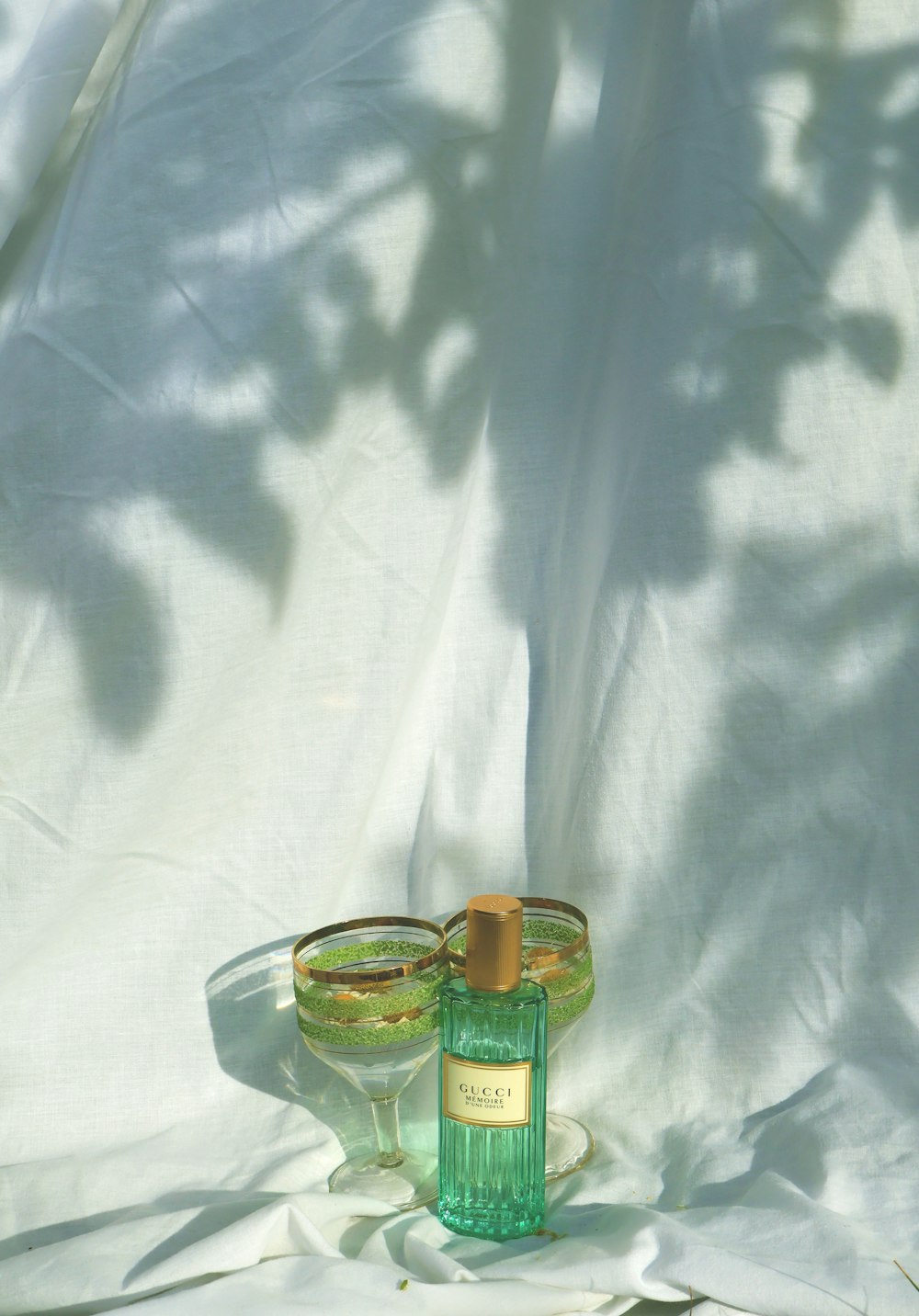 a bottle of wine and two glasses on a white cloth