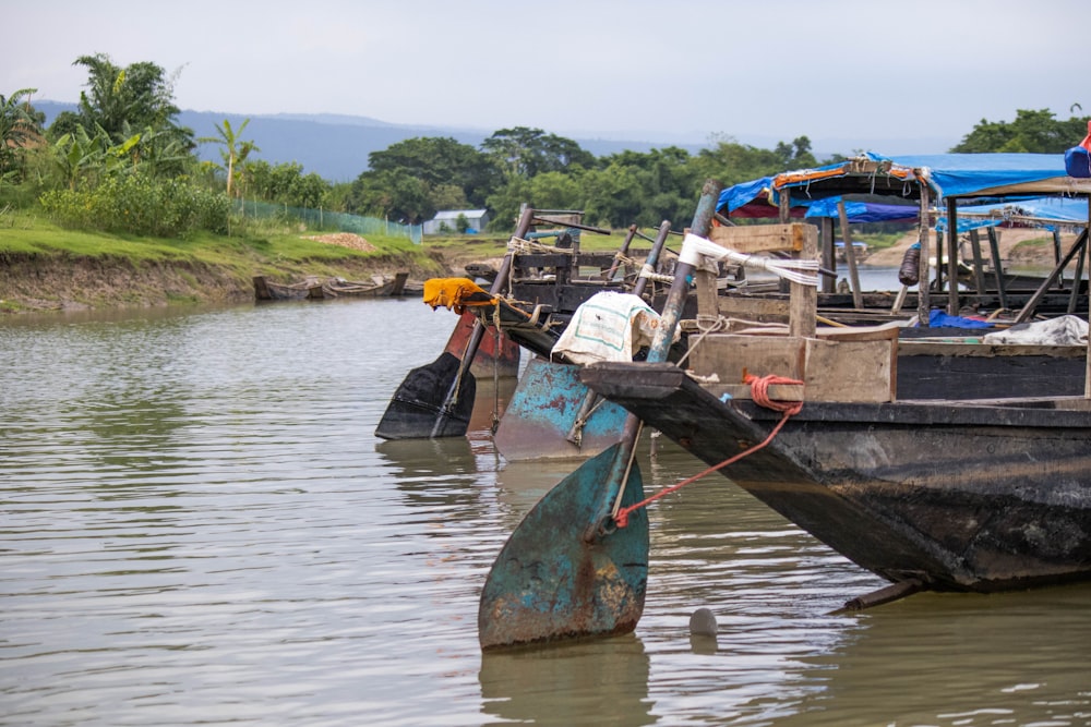 a couple of boats floating on top of a river