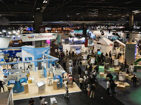 A finished exhibition stand glowing under bright lights at an international event.