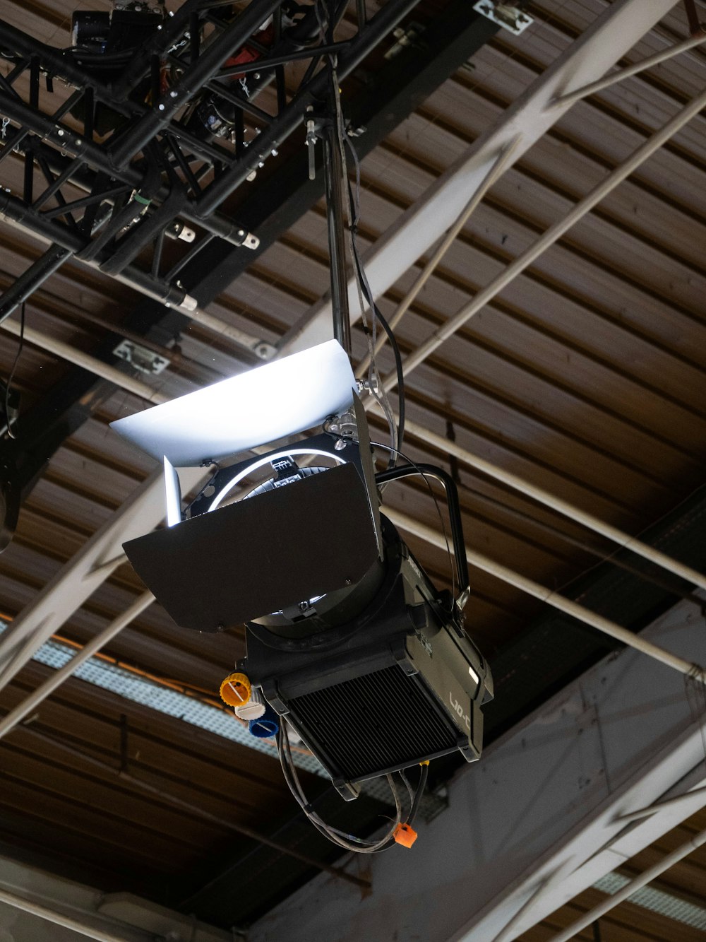 a projector hanging from the ceiling of a building